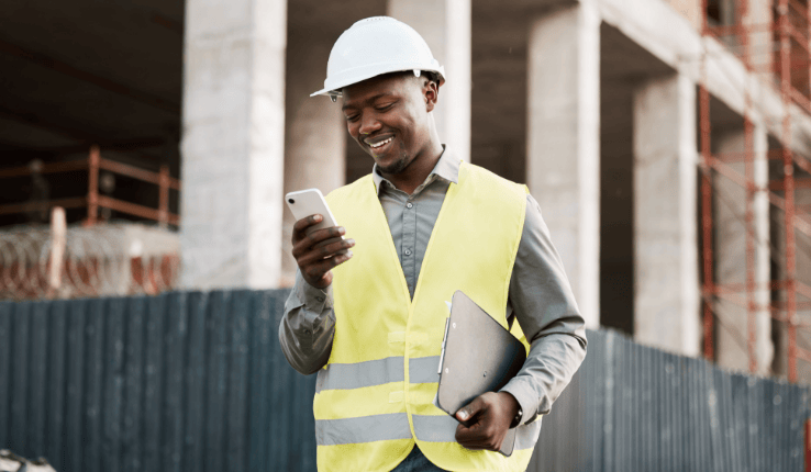 worker looking at employee communication software on his phone