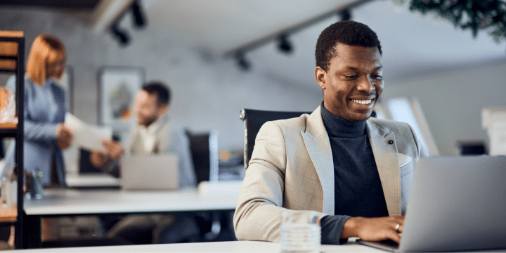 Middle-aged man working solo on his laptop at his desk